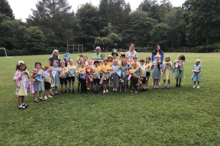 Classes 1 and 2 and their teachers pose for a group photo with Speech House staff