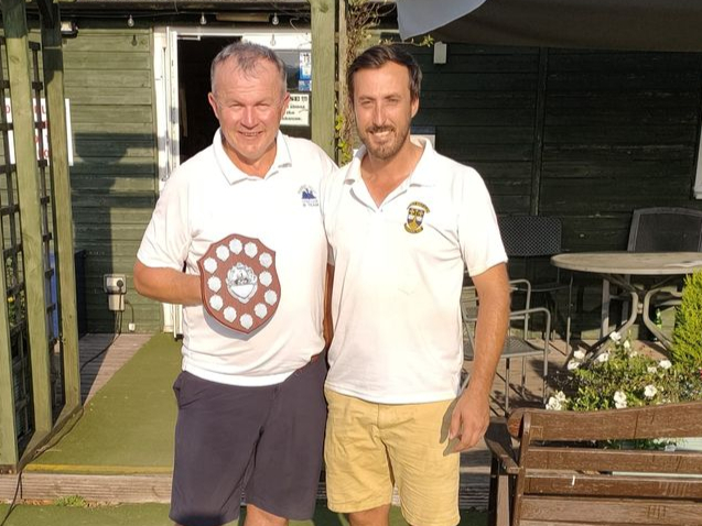 Forest Hills vice-captain Ashley James receives the Steve Briscoe Memorial Trophy from Lydney captain Chris Aldridge.