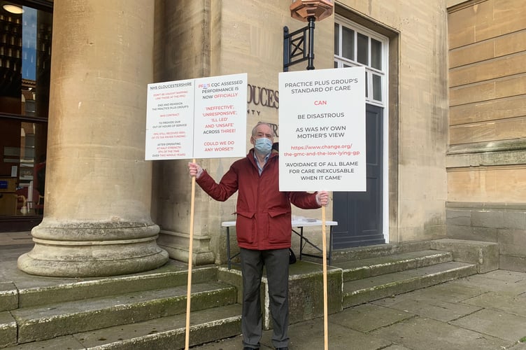 County resident Keith Smith pictured holding placards outside Shire Hall on March 14, 2023