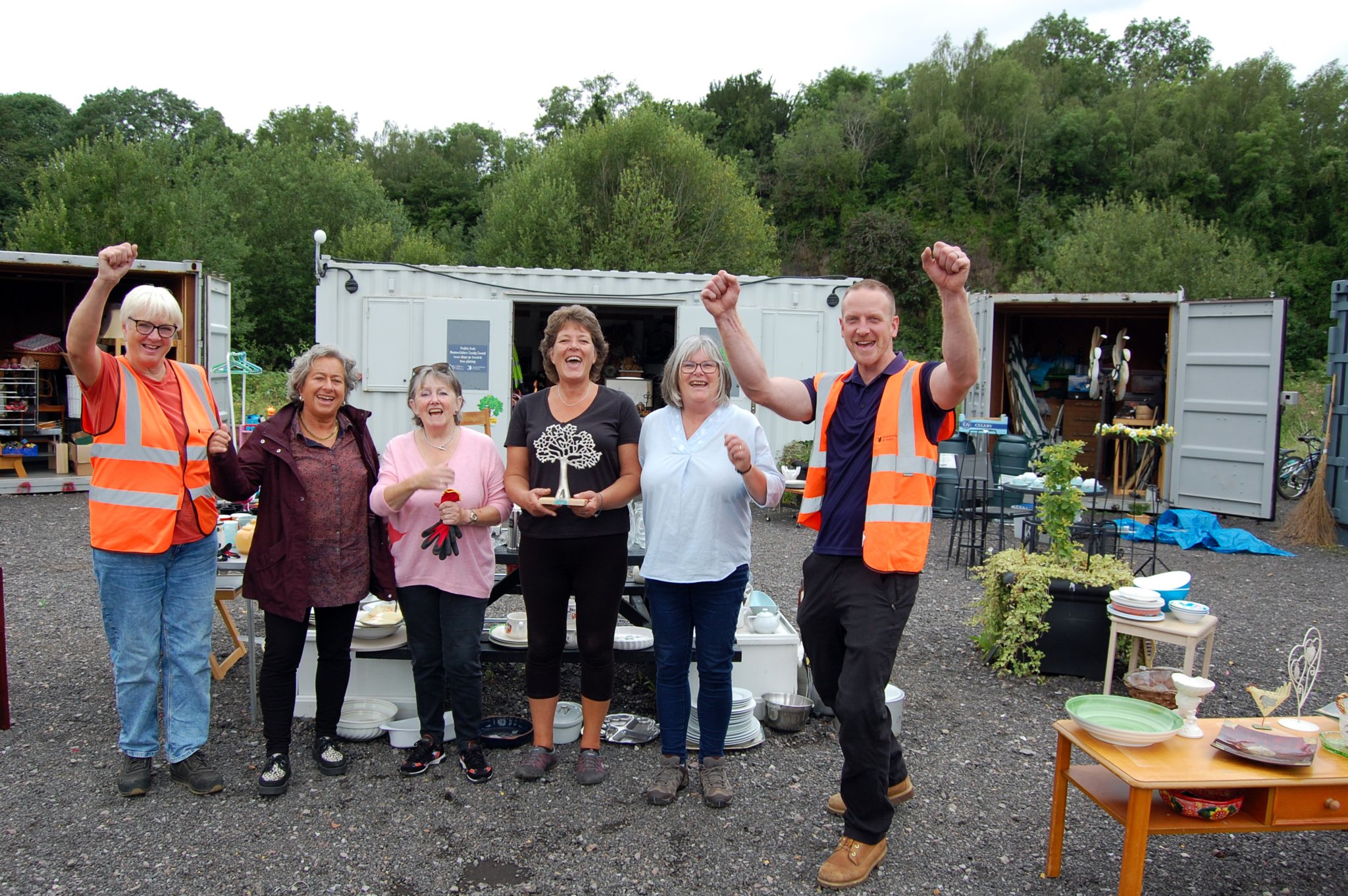 Reuse shop team celebrates community hero award