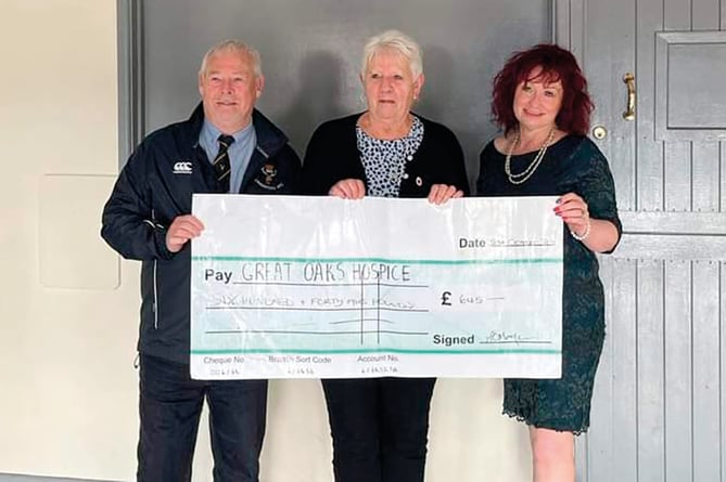Gary Trigg (left) and Andrea Morgan, wife of the late Richard Morgan, present a cheque for £645 to Debbie Hutchinson, fund raising co ordinator for Great Oaks Hospice.