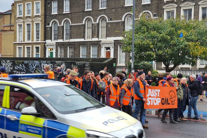 Lydney’s Steve Stockham and Louise Penny (front, holding banner) were arrested for their part in a Just Stop Oil protest march in east London earlier this month. Pic: Just Stop OIl