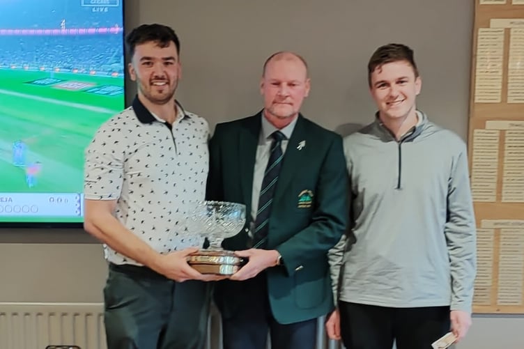 Captain Alan Edwards (centre) presents the Derek Parker Trophy to Scott Ayres and Ryan Burris.