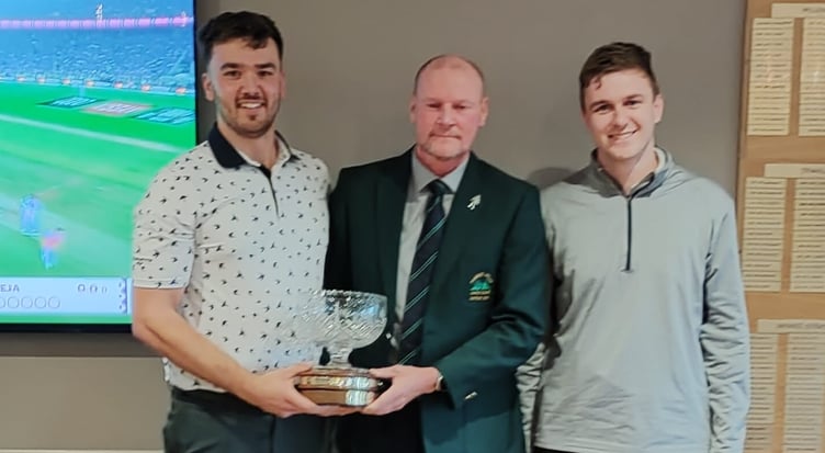 Captain Alan Edwards (centre) presents the Derek Parker Trophy to Scott Ayres and Ryan Burris.