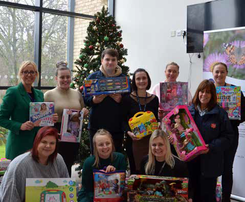 Two Rivers chief executive Hayley Selway (left) and Major Vivienne Prescott of the Salvation
Army (right) and staff with some of the donated toys.