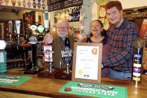 Geoff Sandles, left, chairman of Forest of Dean CAMRA presents Sarah and Tom Gibson with their Forest of Dean CAMRA Pub of the Year 2024 certficate