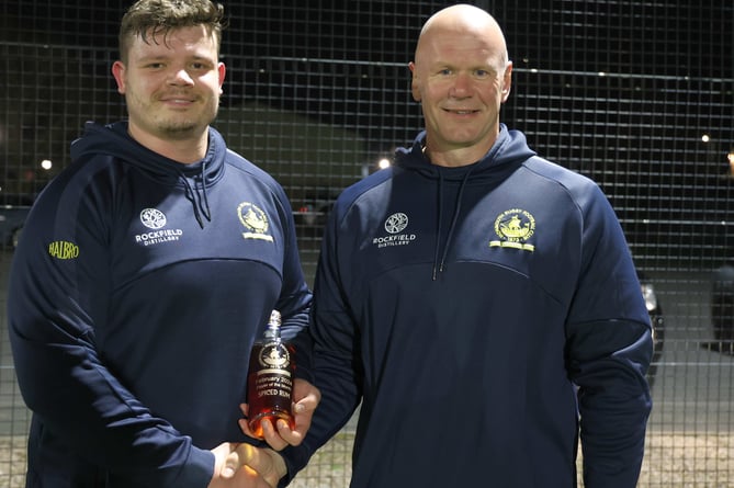 Forester Shaun Hobbs receives Monmouth RFC's Player of the Month from Chay Billen