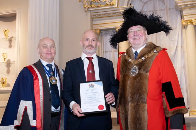 Ben Kerslake is presented with his Master Plasterer certificate by the Lord Mayor of London, Michael Mainelli and the Master of the Worshipful Company of Plaisterers Tony Mitchell (left). Picture: Phil McCarthy Photography.