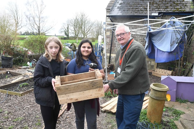 Pupils help with making planters.