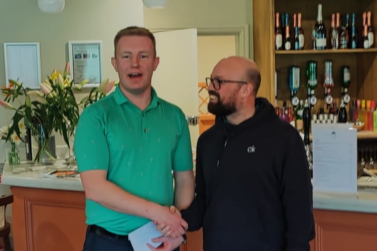 Stu Hardy receives his prize from Jamie Dick