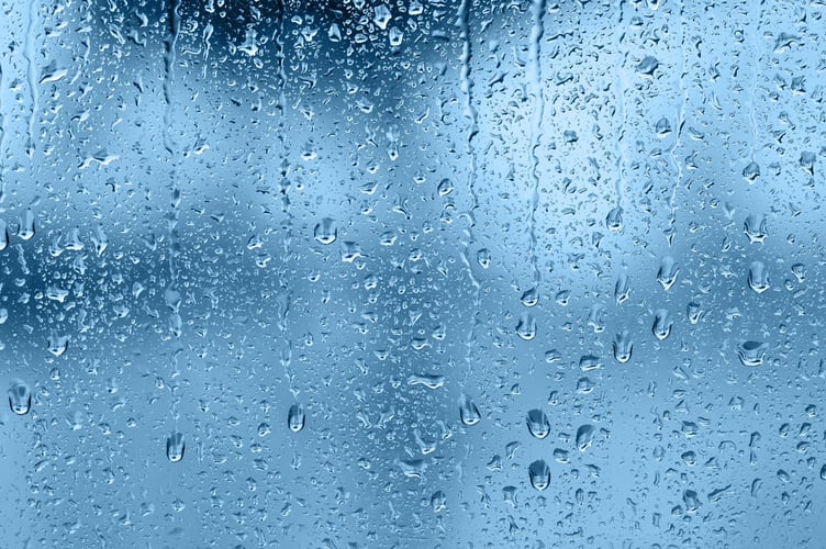 Raindrops on the window, abstract background. Blue tone
