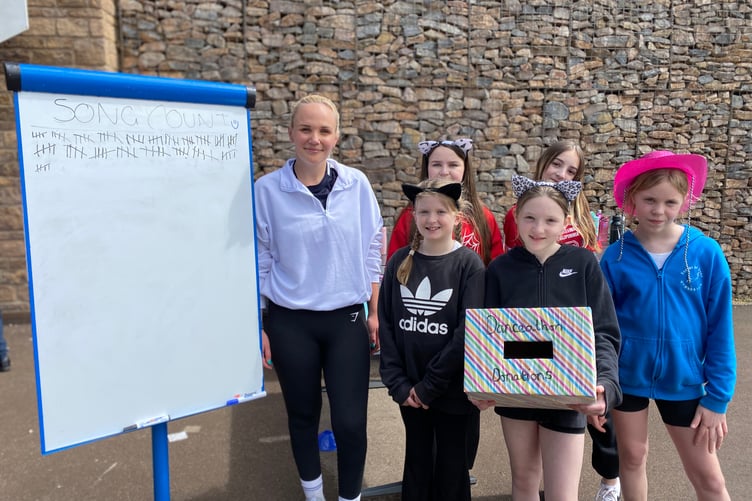 Teacher Chloe Cartwright and pupils tot up the number of songs