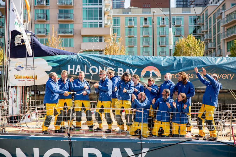 Cue champagne as Eric, third from left, and crew open the bubbly