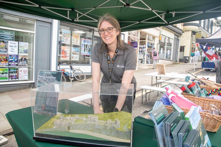 Eleanor Tyrrell, a custodian at Chepstow Castle, with a model of the how the castle would have looked in the 16th century.