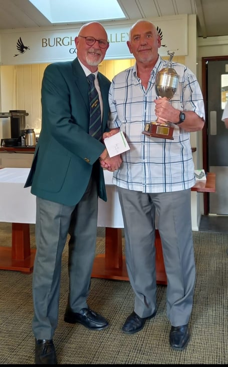 Seniors Captain Alan Bridges, presents Ken Lawrence with the Roy Powell Away Day Trophy.