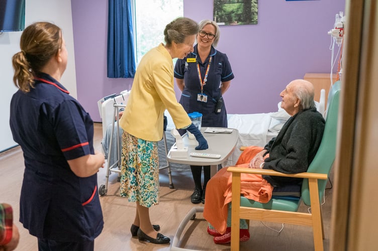 Princess Anne talks with Dennis, a patient.