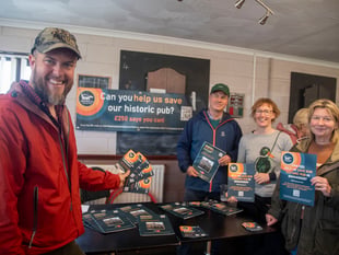 COMMUNITY BUYS IN TO PUB PLAN