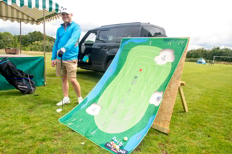 Dave Abraham of the village hall committee with a golf game.