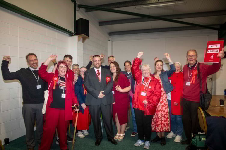New MP Matt Bishop (centre) with Labour supporters after the count.