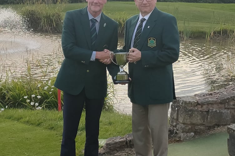 Alan Edwards accepts the Richard Mudge Cup from Chris Dooley of Brickhampton.