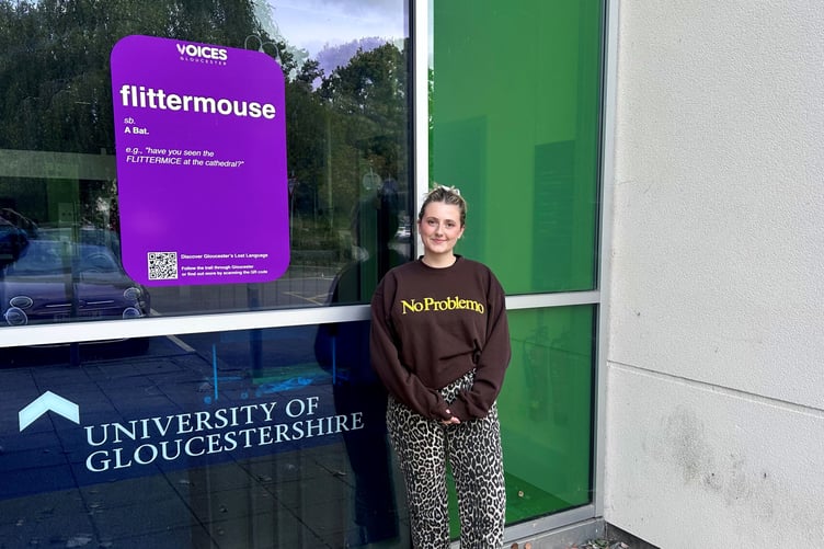 Holly Williams-Richards with one of the Lost Language posters on display at University of Gloucestershire