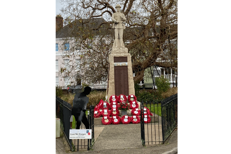 Wreaths cover the base of the Monmouth war memorial
