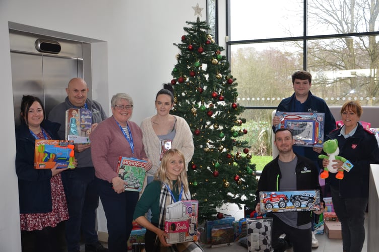 Major Vivienne Prescott (right) with Two Rivers staff and some of the gifts they donated.