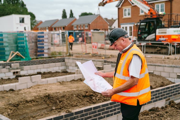 A Bromford site manager looks at construction plans for the site