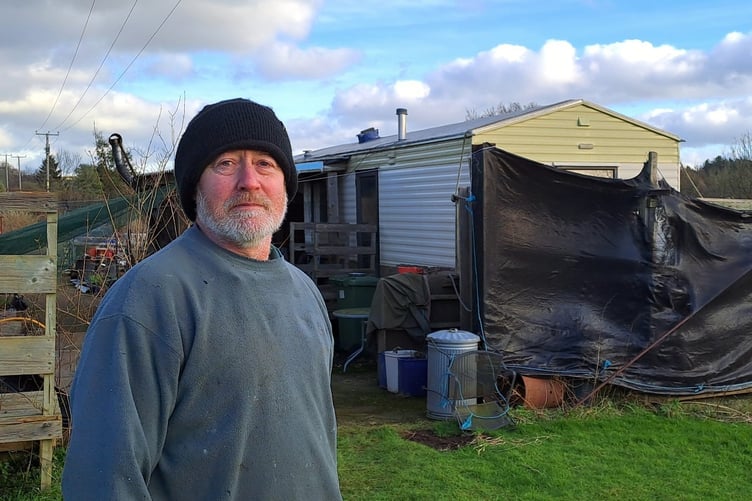 Phil Johnson in front of his mobile home