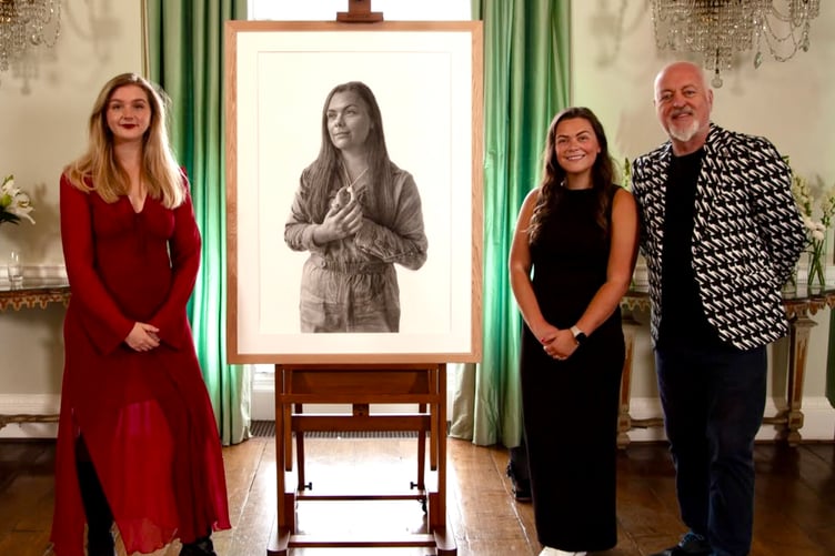Oriane, left, with her portrait, Clare and Bill Bailey