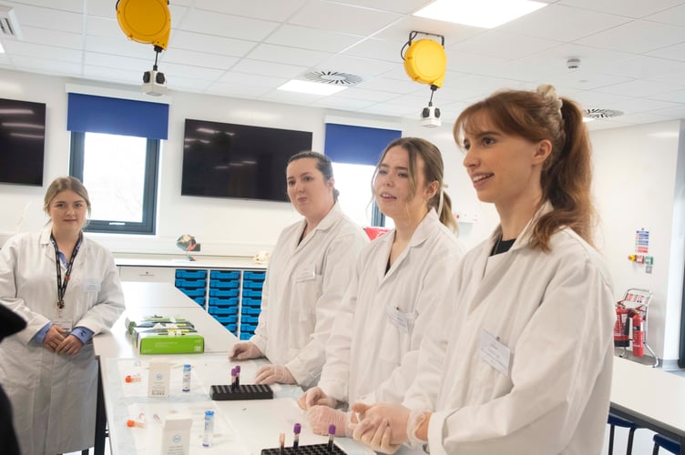 Students Laura Scott, Harriet Shrimpton and Isabelle Fox preparing blood slides and lecturer Daisy Parr (left).