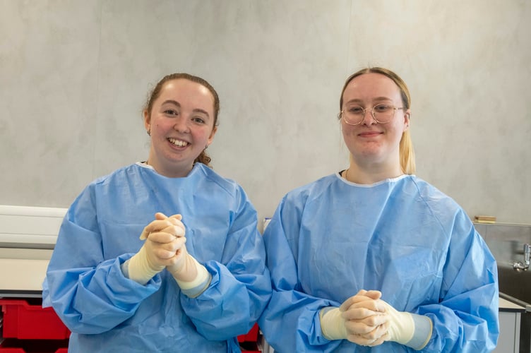 Imogen Balaam and Sarah Page are gloved and gowned.