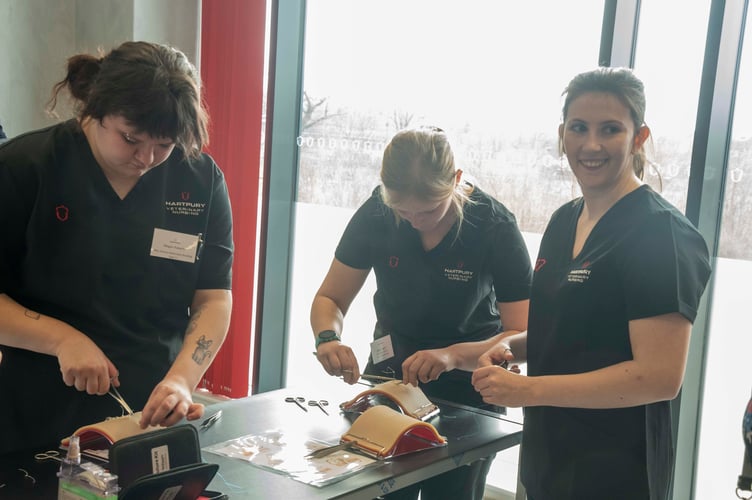 Megan Roberts, Aimee Piggott and Hannah Stone demonstrate stitching techniques.