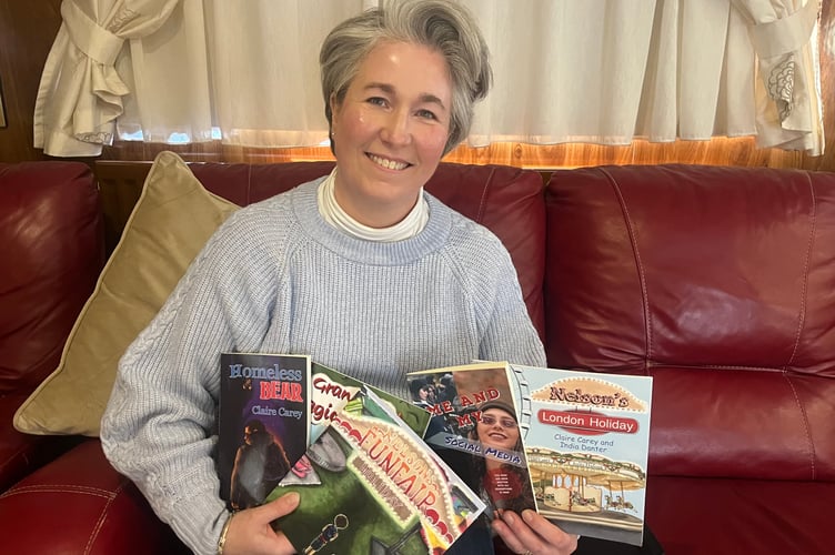Claire Carey with the collection of books written.