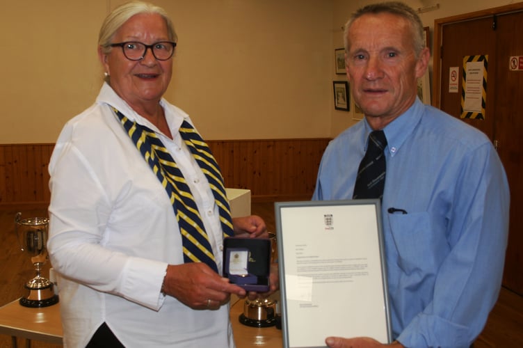 League President Clive Wilkes is presented with his FA long service award from Sue Henson-Green of the Gloucestershire FA.