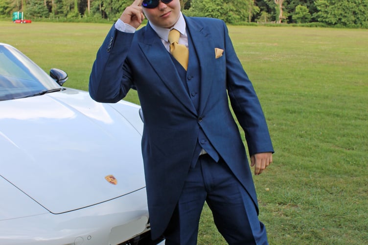 Jayden Gough in front of a Porsche.