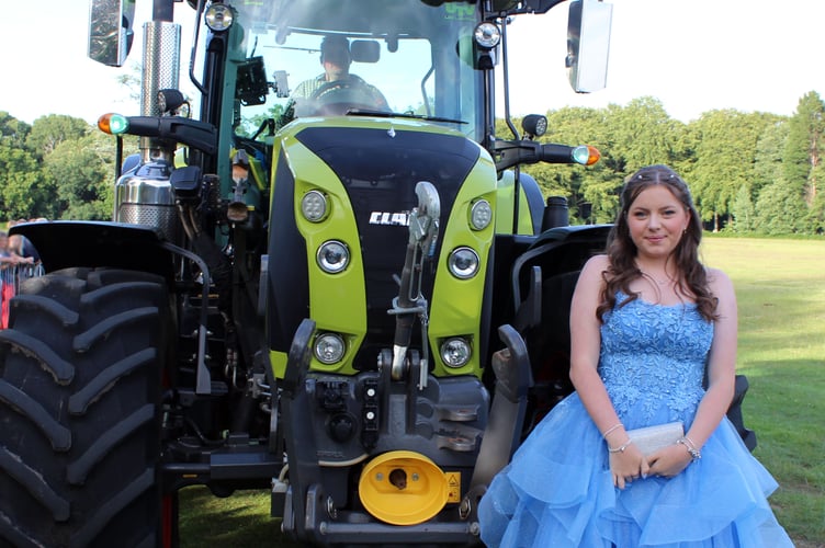 Connie Reeves in front of a tractor.