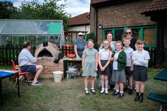 Kids enjoy pizza from oven they built