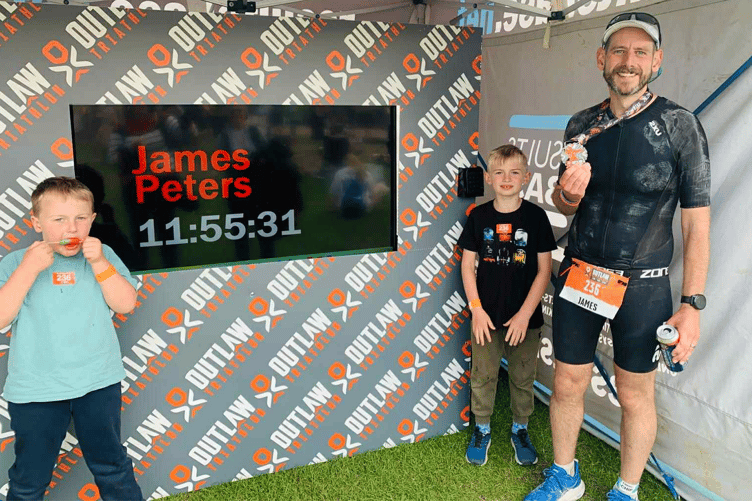 James Peters celebrates triathlon success with sons Henry and William