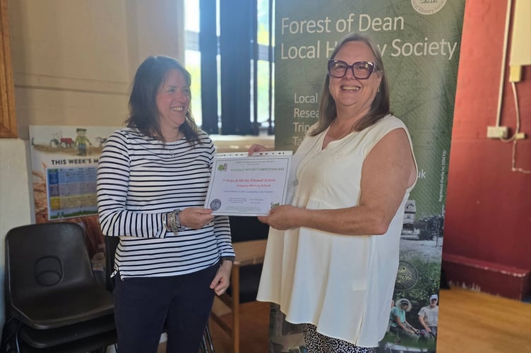 Mrs Nicki Allen (left) is presented with the school winners' certificate on behalf of Pillowell Primary by Sue Newton