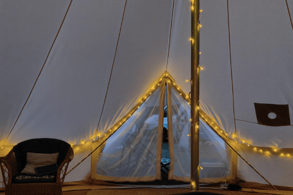A glamping tipi offering an alternative camping experience.