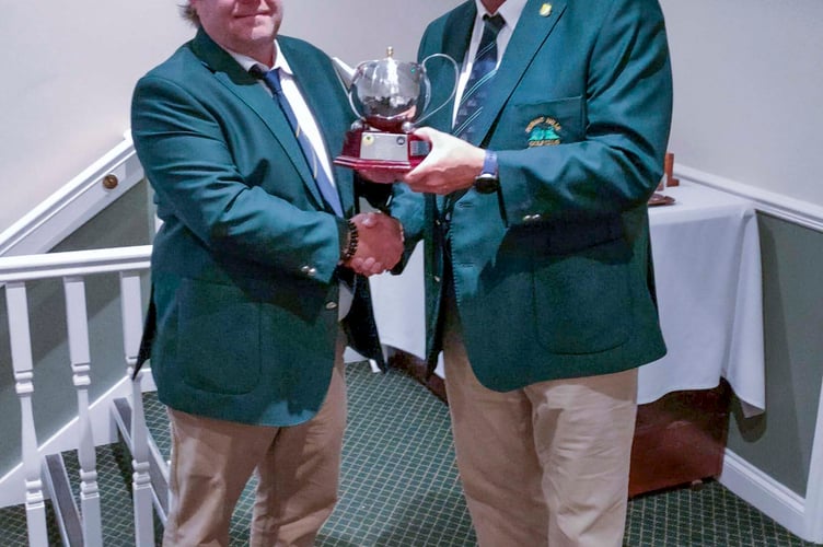 Duncan Buchanan (left, of the Forest of Dean club )receivies the Mo Pearce Tee Pot Trophy from Mark Graham.
