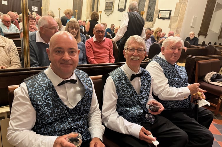 Choristers enjoy a break and a glass of wine.