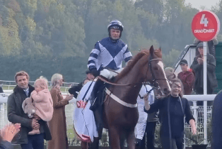 Sam Thomas with his daughter, left, is all smiles as Celtic Dino returns in triumph after landing the DragonBet Welsh Champion Hurdle.
