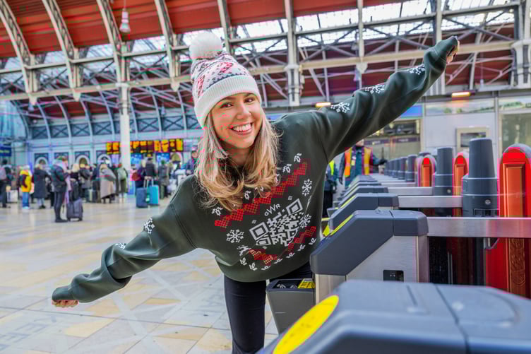 A GWR Christmas jumper being scanned at a station barrier as part of the festive travel giveaway.