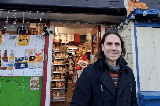 Cllr Johnathan Lane promotes the Shop Local competition during a visit to Netherend Stores in Woolaston.