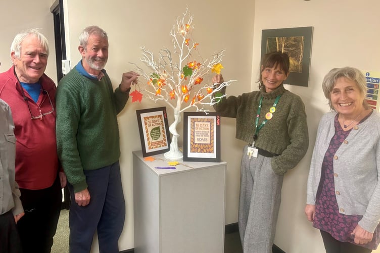 Council staff and councillors standing alongside the pledge tree at the Coleford offices as part of the 16 Days of Action campaign.