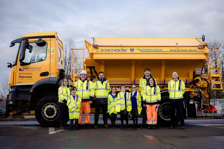 Councillor Joe Harris with competition winners and Benji the Baltic Blaster, one of Gloucestershire’s newly named gritters ready for winter roads.