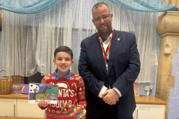 Forest of Dean MP Matt Bishop with competition winner Willoughby from Huntley Church of England Primary School, proudly holding his winning Christmas card design.