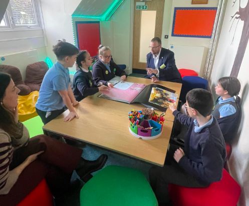 Matt Bishop MP looking through pupil projects at Yorkley Primary School.